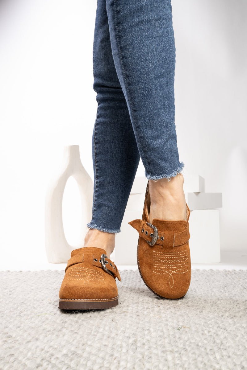 Brown Mules on Feet with frayed jeans