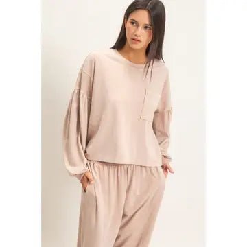 Women wearing beige loose fit top and bottoms