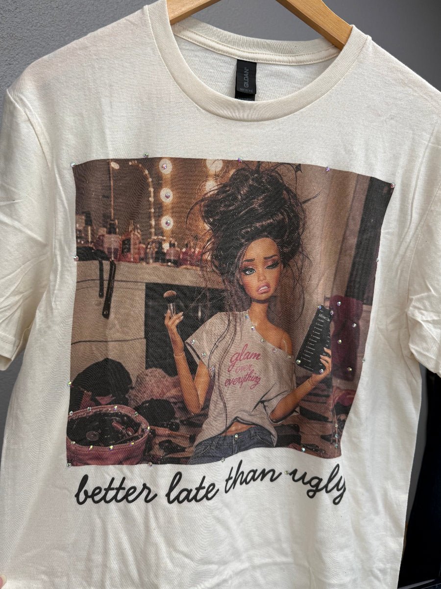 Natural Cotton T-Shirt With Graphic Better Late Than Ugly Doll surrounded by makeup and bling
