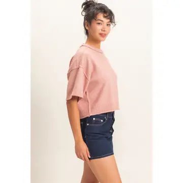 Woman wearing a pink sweater and skirt