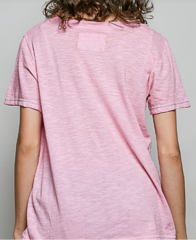 A person viewed from the back wearing a light pink short-sleeve t-shirt with a heathered texture and subtle contrast stitching on the sleeve cuffs, set against a plain light gray background.