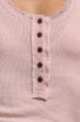 Close-up of a light pink ribbed knit top with a three-button henley neckline.