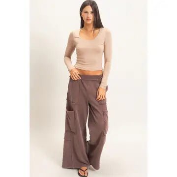 Female in Cream Shirt and Brown Pants wearing flip flops