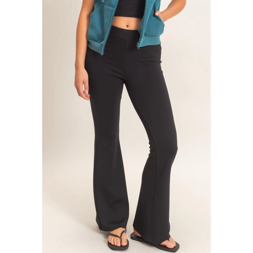 Black Flare elastic waist pants, black flip flops, black tank and teal vest