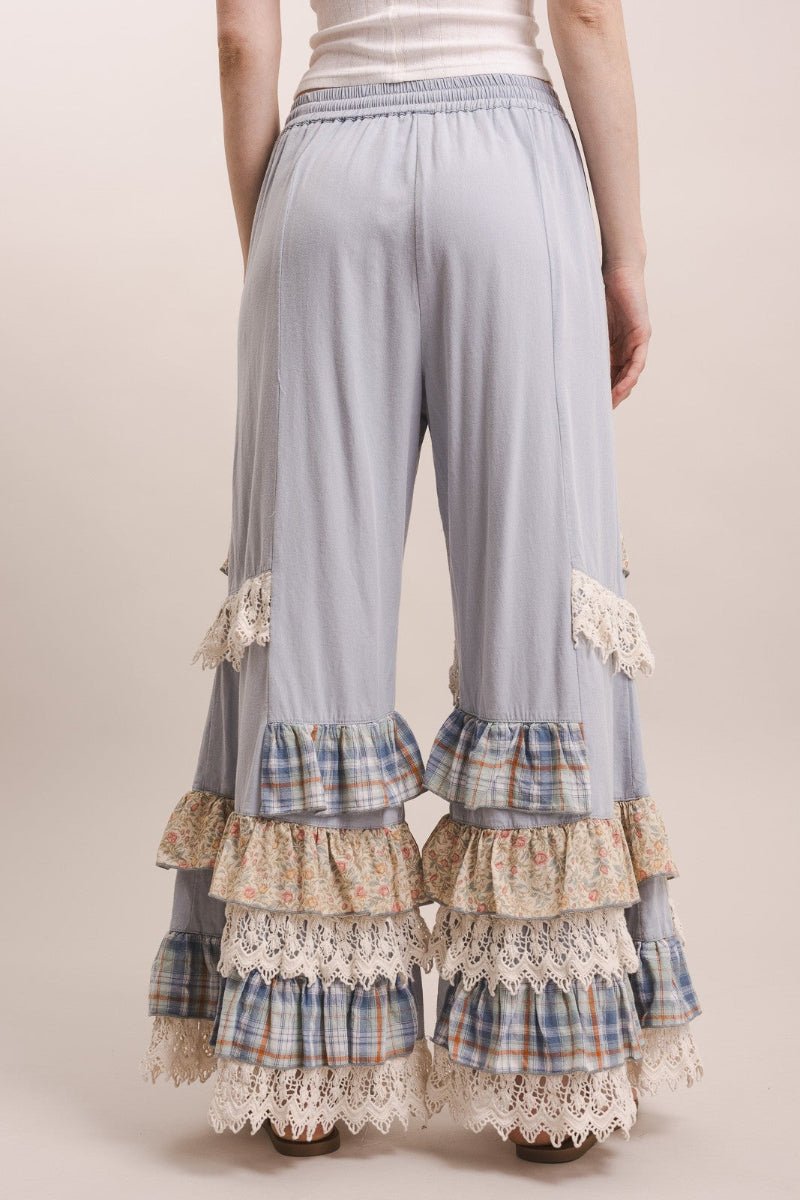 Light blue pants with plaid and lace details on a beige background