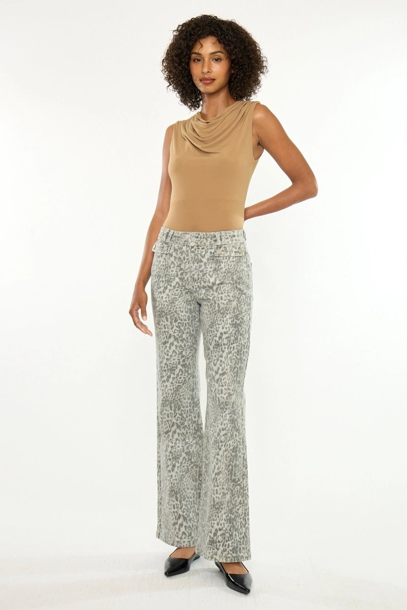 A woman modeling a tan sleeveless cowl-neck top and light gray patterned wide-leg pants against a plain white studio background.