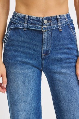 Blue jeans worn by a person on a white background