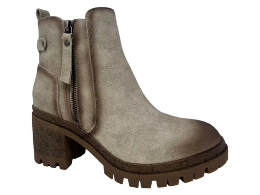 A taupe-brown suede ankle boot with a side zipper, chunky block heel, and rugged lug sole, shown against a plain white background.