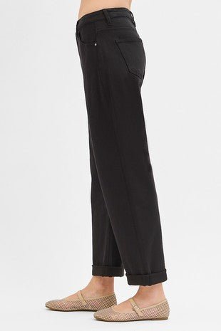 Black pants worn by a person on a white background