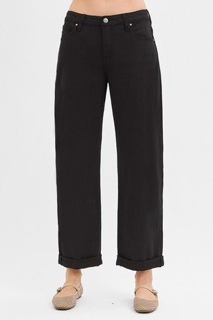 Black jeans worn by a person on a white background
