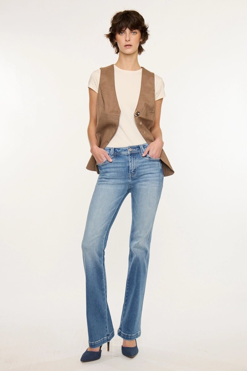 Person wearing a brown vest, white shirt, and blue jeans on a white background