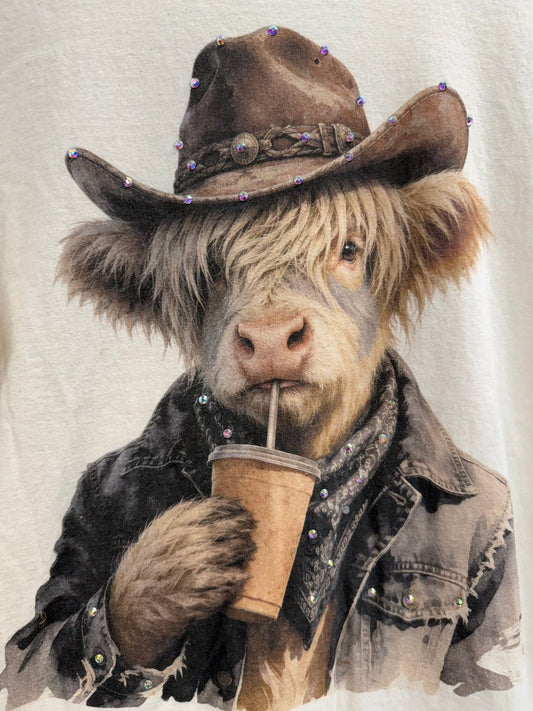 Cow wearing cowboy hat sipping iced coffee
