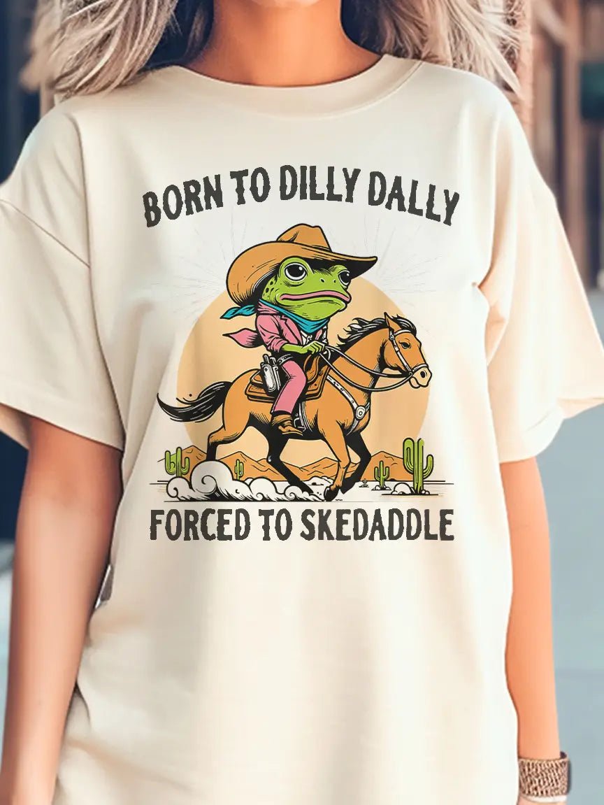 Green Frog on a brown horse with the text Born To Dily Dally Forced To Skedaddle