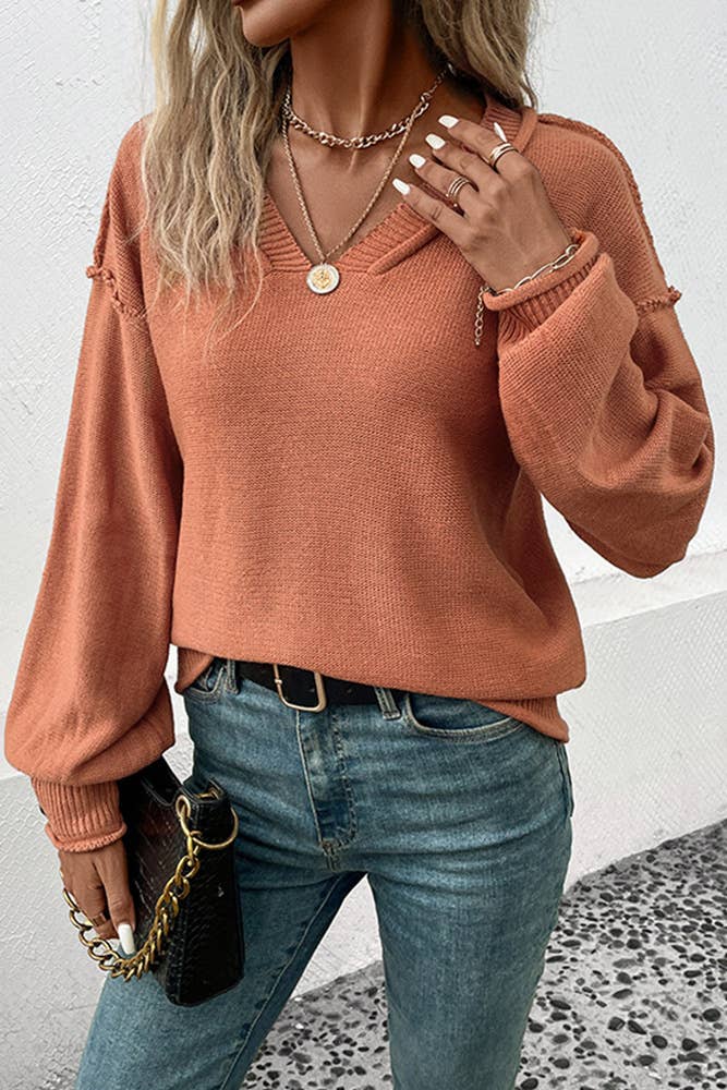 Model Wearing Coffee Color Sweater and Jeans holding a black purse