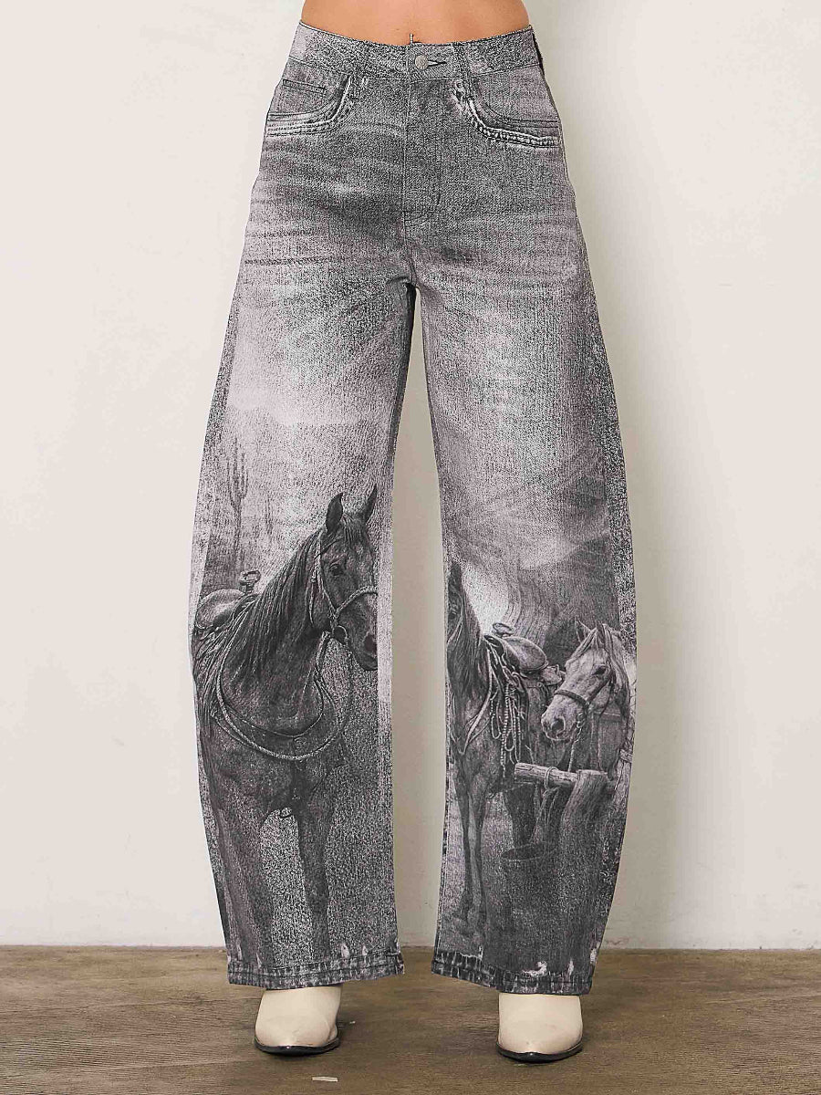 Wide-leg gray jeans with a black and white western horse print, shown on a model from the waist down against a plain light wall.