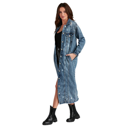 Woman wearing a long denim jacket on a white background