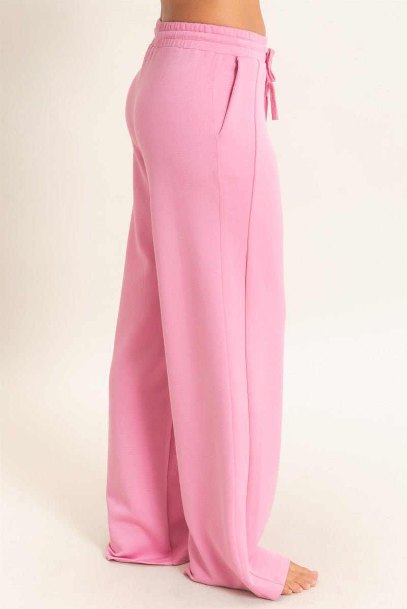 Pink sweatpants on a beige background