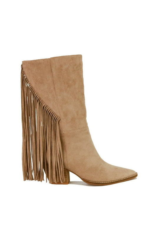 A light tan suede ankle boot with a pointed toe and a long fringe detail cascading down the outer side, set against a plain white background.
