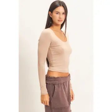 Female wearing long sleeve scoop neck t-shirt and brown pants