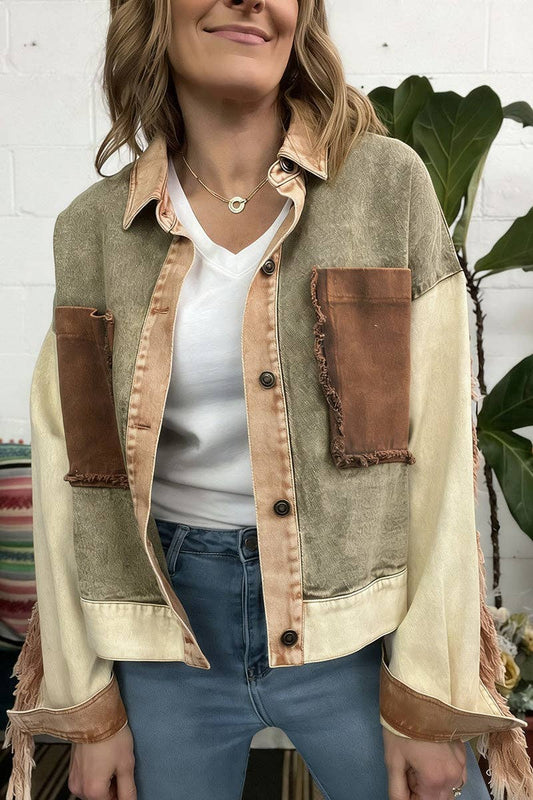Woman wearing a patchwork jacket with brown and beige colors against a white brick wall.